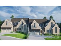 Charming gray brick home with a two-car garage and meticulously landscaped front yard at 2113 Brandon Cir, Charlotte, NC 28211