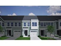 Charming townhouse featuring a one-car garage, a black front door, and light green siding at 2708 Lehigh Rd, Charlotte, NC 28208