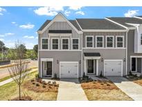 Charming gray townhouse with a one-car garage, well-manicured lawn, and inviting curb appeal at 2712 Lehigh Rd, Charlotte, NC 28208