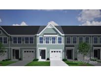 Charming exterior elevation of a modern townhome with green siding, white trim, and attached garage at 2712 Lehigh Rd, Charlotte, NC 28208