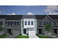 Charming townhome featuring light green siding, a one car garage, and a neatly trimmed front lawn at 2720 Lehigh Rd, Charlotte, NC 28208