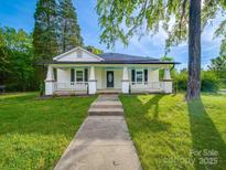 Charming home with a welcoming front porch and well-manicured lawn, perfect for relaxing outdoors at 300 W 12Th St, Salisbury, NC 28144