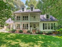 Charming two-story home with a double porch, black shutters, and a lush, well-maintained lawn at 4951 Dayspring Dr, Mint Hill, NC 28227