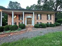 Charming brick home with a well-manicured lawn and inviting front porch with columns at 5495 Valley Run St, Hickory, NC 28601