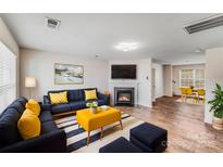 Comfortable living room with a cozy fireplace and stylish contemporary furnishings at 7205 Finnigan Rd, Charlotte, NC 28215