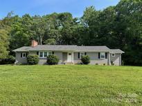 Charming single-story home with a well-manicured lawn, mature trees, and neutral painted brick at 7860 Henry Harris Rd, Fort Mill, SC 29707