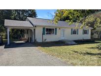 Charming single-story home with a carport and a well-maintained front yard at 824 S Laurel St, Lincolnton, NC 28092