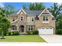 Beautiful brick home boasts stone accents, an attached two-car garage, and well-maintained landscaping at 862 Kathy Dianne Dr, Fort Mill, SC 29707
