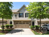 Charming townhouse with a two-car garage, brick accents, and manicured landscaping at 12009 Elizabeth Madison Ct, Charlotte, NC 28277