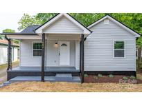 Charming home featuring a covered front porch and well-manicured landscaping at 1440 10Th Sw Ave, Hickory, NC 28602