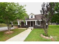 Charming home with a welcoming front porch and a well-manicured lawn showcasing curb appeal at 175 Leonard Rd, Salisbury, NC 28146