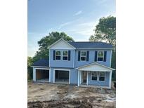 Two story house with two garages and light blue siding under a clear sky at 211 N Gregory St, Lancaster, SC 29720