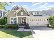 Charming single-Gathering home featuring a manicured lawn and an attached two-car garage at 214 Blossom Ridge Dr, Mooresville, NC 28117