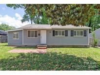 Charming one story home with a well-maintained lawn and brick pathway at 2409 Thornton Rd, Charlotte, NC 28208