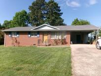 Charming brick home with a covered carport and well-manicured lawn, showcasing its inviting curb appeal at 2583 Robinson Rd, Newton, NC 28658