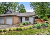 Charming single-story home with well-maintained landscaping, brick accents, and a cozy front porch at 2750 Victory Ct, Fort Mill, SC 29715