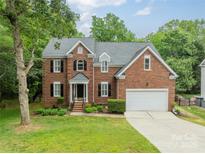 Charming brick home with a well-manicured lawn and two-car garage at 2907 Notchview Ct, Charlotte, NC 28210