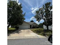 Charming one-story home featuring an attached garage and well-maintained front yard at 3012 Longspur Dr, Matthews, NC 28105