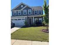 Charming two-story home with a well-manicured lawn, a two car garage and covered porch at 3023 Ballester Rd, Fort Mill, SC 29707