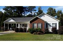 Charming single-story home with a brick facade, white siding, and a covered front porch at 625 Wildwood Dr, Rock Hill, SC 29730