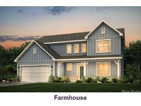 Charming two-story home with gray siding, white trim, and an inviting front porch at 7040 Stella Pl, Stanley, NC 28164