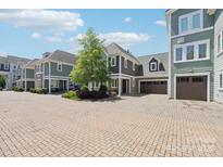 Inviting curb appeal showcasing a paver driveway and well-maintained townhome community with ample parking at 7908 Rea View Ct, Charlotte, NC 28226