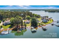 Expansive waterfront property featuring lush landscaping, private docks, and stunning lake views at 9561 Island Point Rd, Sherrills Ford, NC 28673