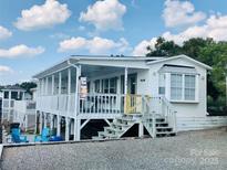 Charming single-story home featuring a large screened porch and inviting curb appeal at 108 Britt Ln, New London, NC 28127