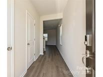 Inviting hallway featuring hardwood floors, neutral paint, and a glimpse into the living area at 111 Canoga Ave, York, SC 29745