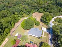 Expansive aerial view of the home and wooded lot showcasing privacy and outdoor space at 1111 Unionville Church Rd, Monroe, NC 28110