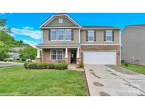 Charming two-story home with stone accents, well-maintained lawn, and attached two-car garage at 12217 Dearview Ln, Charlotte, NC 28269