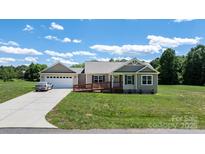 Charming single-story home with a two car garage, handicap ramp, and well-maintained lawn at 125 Carter Ln, Statesville, NC 28625
