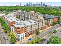 Stunning aerial view of apartment building with skyline in the background at 1315 East Blvd # 410, Charlotte, NC 28203