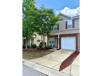 Inviting townhome with a well-manicured lawn and attached one-car garage at 13612 Singleleaf Ln, Charlotte, NC 28278