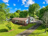 Charming brick ranch-style home with a long driveway and mature trees on a sunny lot at 1408 Delview Rd, Cherryville, NC 28021
