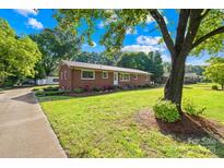 Charming brick home with lush landscaping and a well-manicured lawn, creating a welcoming curb appeal at 1408 Delview Rd, Cherryville, NC 28021