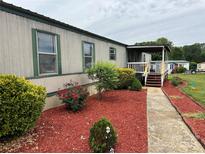 Charming single-story home featuring a cozy front porch and well-maintained landscaping at 181 Trivette Rd, Harmony, NC 28634