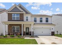 Inviting two-story home with a charming front porch and well-maintained landscaping at 3643 Slider Ter, Lancaster, SC 29720