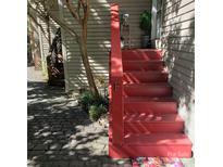 Welcoming red staircase leading to the front door with charming landscaping at 415 W 7Th St # F, Charlotte, NC 28202