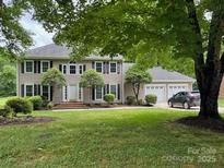 Charming two-story home features a manicured lawn and attached two car garage at 4509 Patriots Way, Gastonia, NC 28056
