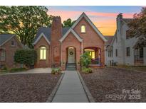 Charming brick home featuring a cozy front porch and well-manicured landscaping at 501 Pee Dee Ave, Albemarle, NC 28001