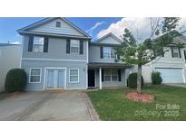 Charming two-story home featuring a well-maintained lawn and classic architectural details at 5141 Grays Ridge Dr, Charlotte, NC 28269