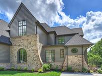 Charming, two-story home featuring a blend of brick and gray siding, complemented by meticulously manicured landscaping at 536 Hillside Ave, Charlotte, NC 28209