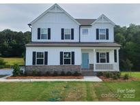 Charming two-story home with a welcoming front porch and classic architectural details at 5630 Galloway Dr # 49, Stanfield, NC 28163
