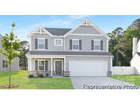Charming two-story home featuring gray siding, a two-car garage, and a well-maintained front yard at 5630 Galloway Dr # 49, Stanfield, NC 28163