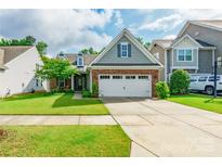 Charming home featuring a well-manicured lawn, brick accents, and a two-car garage in a residential neighborhood at 640 Mackenzie Falls Dr, Fort Mill, SC 29715