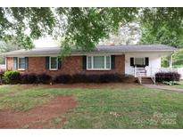 Charming brick home with black shutters and mature landscaping at 723 Rabun Ln, Rock Hill, SC 29730