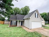 Charming single Gathering home with attached garage, green lawn, and lovely curb appeal with mature trees at 7321 Mapleridge Dr, Charlotte, NC 28210