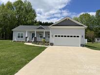 Charming single-story home with a two-car garage and a welcoming front porch at 1119 Balls Creek Rd, Claremont, NC 28610