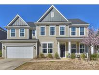 Charming two-story home with a well-manicured lawn and attached two-car garage, inviting curb appeal at 2025 Sweet Magnolia Ln, Clover, SC 29710
